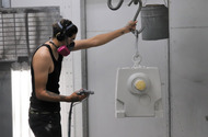 NORD employee spray painting a gear unit